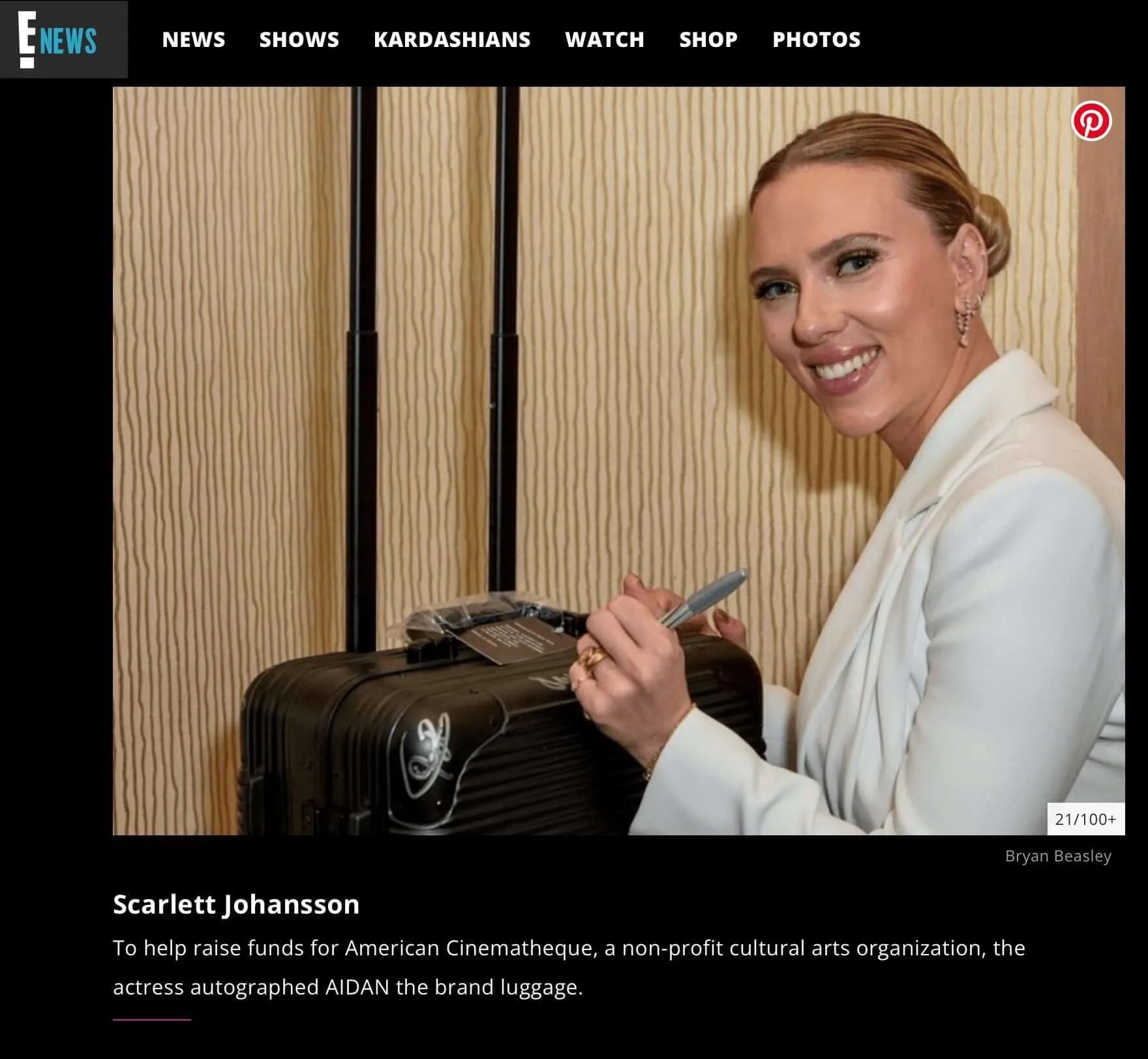 Scarlett Johansson autographs AIDAN luggage for American Cinematheque Gala fundraising event.